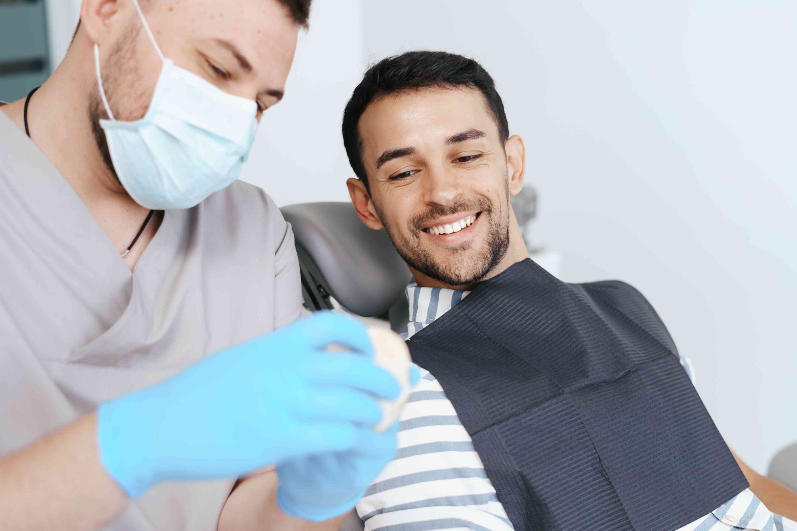 Smiling patient reviewing treatment information with a dental professional.