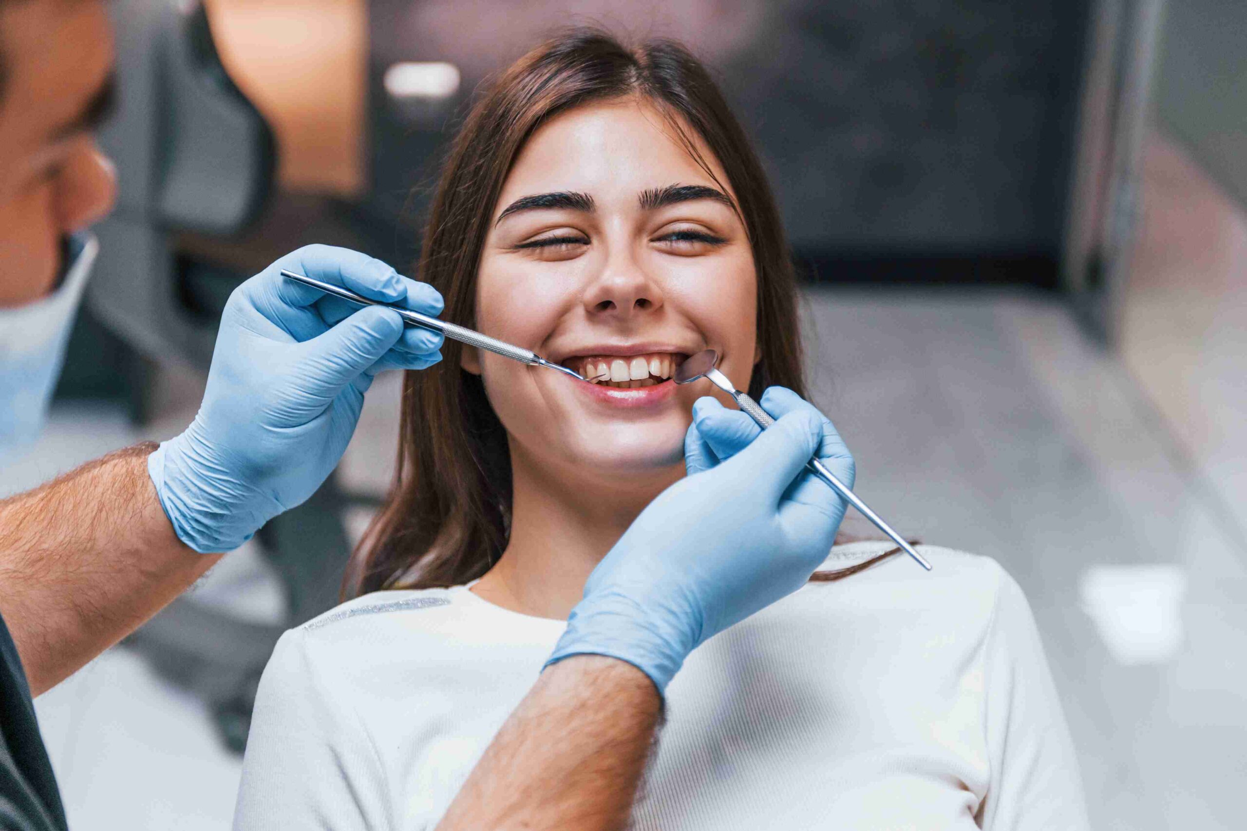 Smiling patient during a dental bonding procedure.